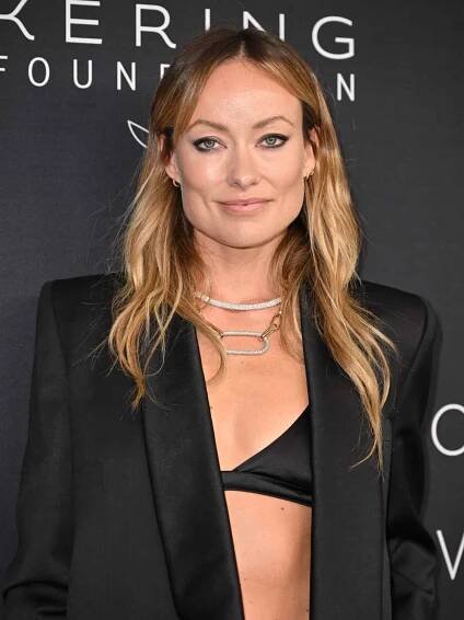 Olivia wilde in an oversized black blazer with a black triangle bra and steep angled brows - InStyle Brow Shapes