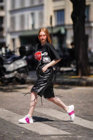 Larsen Thompson wearing knee-length leather shorts and tee during Paris Fashion Week