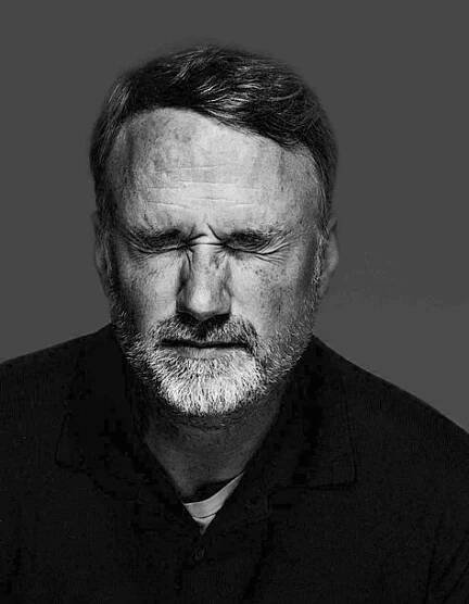 a black and white photo of a man with a beard
