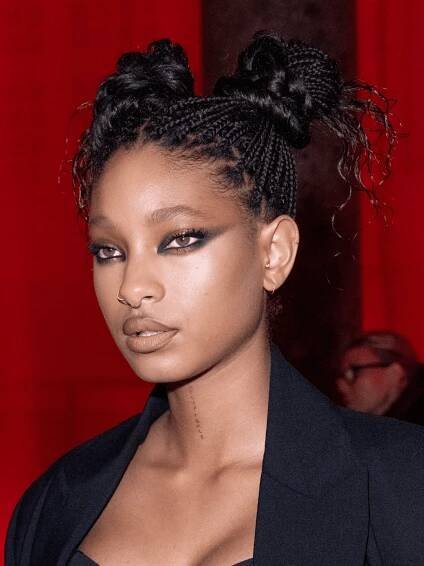 Willow Smith wearing knotless goddess braids in space buns
