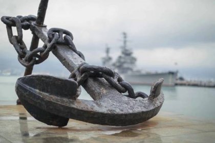 Anchor on the embankment and the cruiser "Mikhail Kutuzov" in the port of Novorossiysk, Russia, anchor, parts of a ship