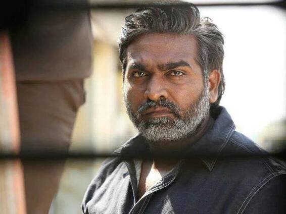 Vijay Sethupathi caught in a candid pose amidst train tracks. Wallpaper