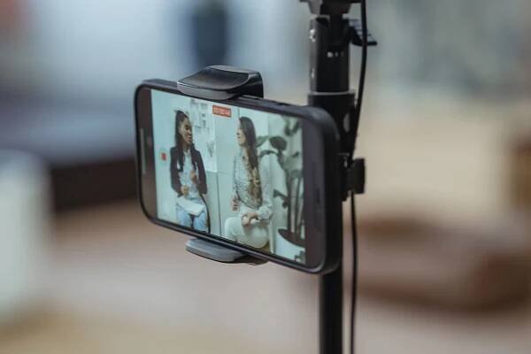 Phone on a stand ready to record people