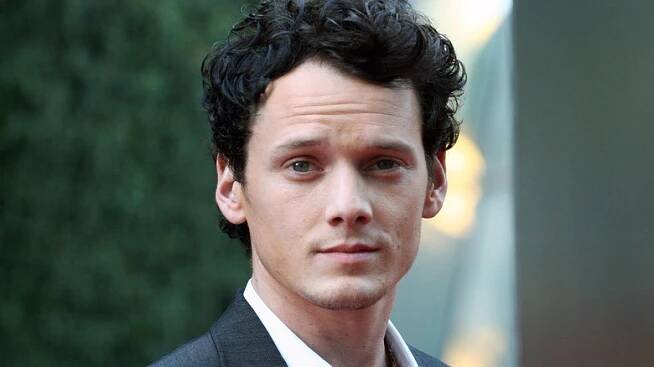 Anton Yelchin smirking at camera