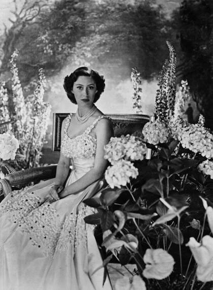 an old black and white photo of a woman in a dress