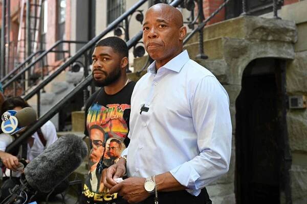 Brooklyn borough president Eric Adams and his son Jordan Coleman (L) host a breakfast with reporters at his house in the Bedford-Stuyvesant neighborhood of Brooklyn.