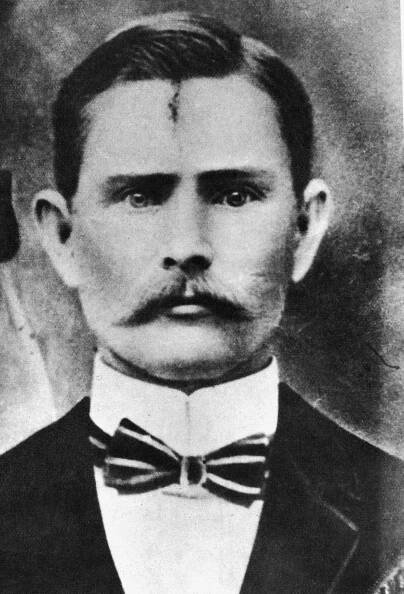 an old black and white photo of a man with a mustache