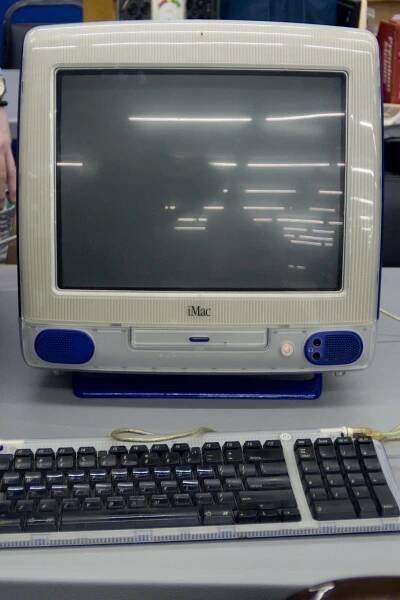 An early 1999 Grape iMac. Its power button is glowing orange, but the machine is not powered on.