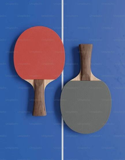 Two ping pong paddles and a ping pong paddle