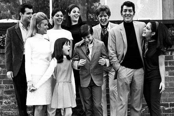 Craig Martin, Claudia Martin, Gail Martin, Dean-Paul Martin, Jeanne Martin, Gina Martin, Ricci Martin, Dean Martin, and Deana Martin pose for a family portrait circa 1966 at their home in Los Angeles, California. 