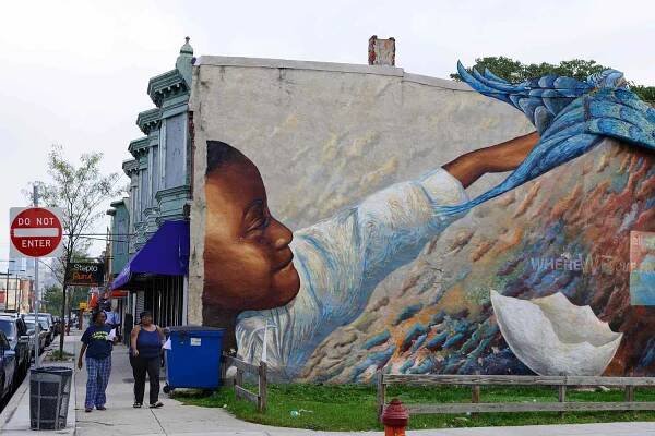 Massive mural on the side of a building in Philadelphia that is part of the Mural Art Program