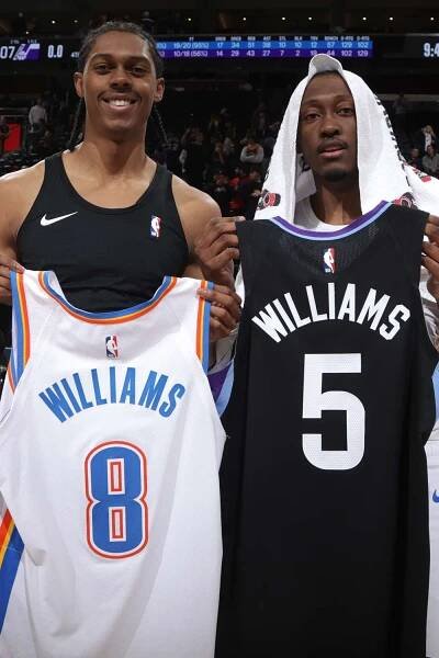 Cody Williams #5 of the Utah Jazz and Jalen Williams #8 of the Oklahoma City Thunder swap jerseys after the game on February 21, 2025 in Salt Lake City, Utah.