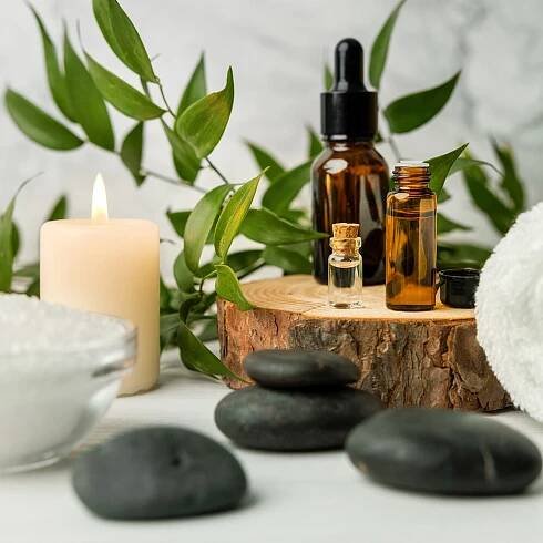 beauty treatment items for spa procedures on white wooden table