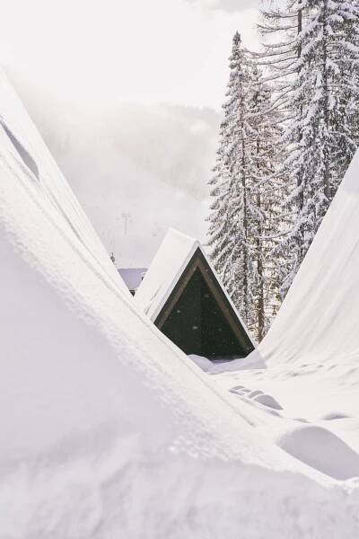 a tent in the snow with trees in the background at TRIFORÊT alpin resort in Hinterstoder