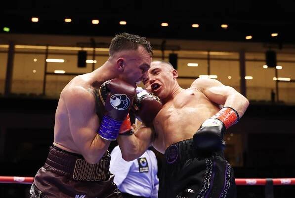 Nick Ball punches Sam Goodman during a boxing match.