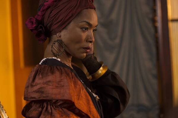 Wearing a tignon, Angela Bassett channels voodoo queen Marie Laveau.