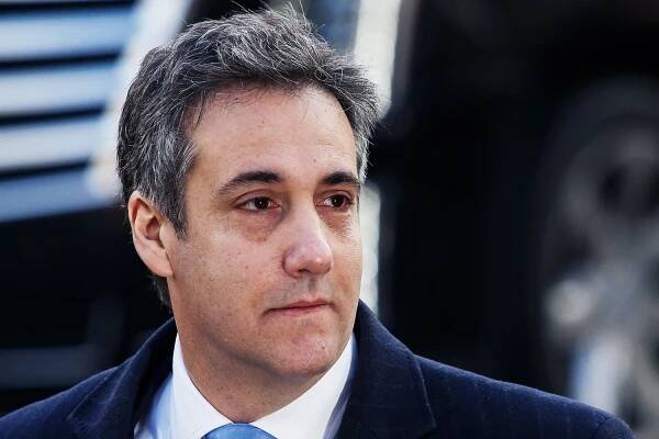 Image may contain Tie Accessories Accessory Face Human Person Michael D. Cohen Coat Suit Clothing and Overcoat