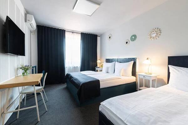 Postel nebo postele na pokoji v ubytování Hotel Maroli Mikulov