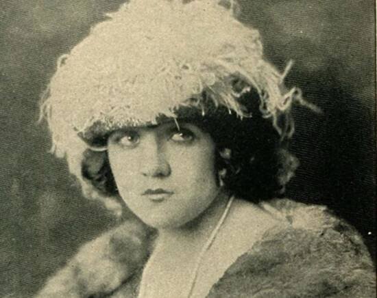 Marie Prevost wearing winter coat and hat is looking at side -1923