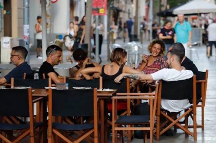 A group of friends at a sidewalk café in Barcelona.