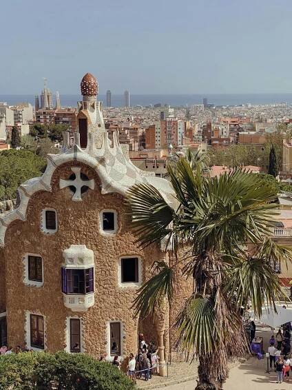 Free Iconic Gaudí architecture at Park Güell with a view of Barcelona cityscape and the Mediterranean Sea. Stock Photo