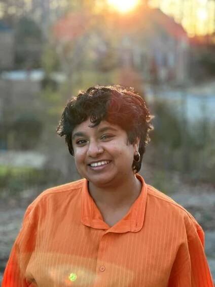 Portrait of Tarunika Anand in an orange shirt