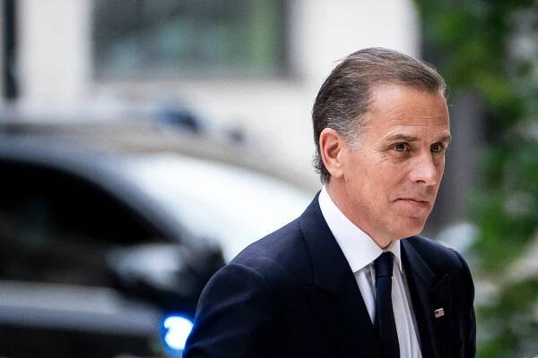 Hunter Biden, wearing a dark blue suit and blue tie.