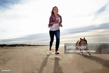 girl ( 14-16) training dog on beach - young teen girl beach stock pictures, royalty-free photos & images