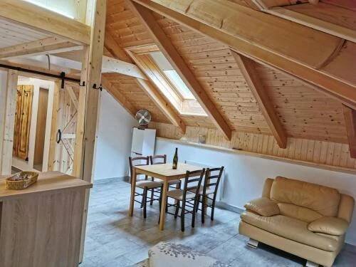 a kitchen and dining room with a table and chairs at Apartmány Nová duha Vavřinec in Vavřinec