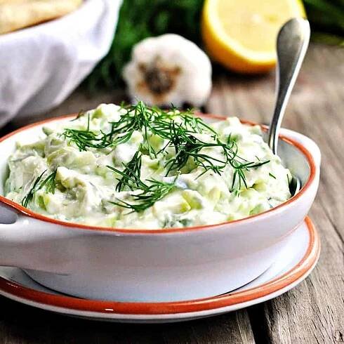 Tzatziki-Sauce served in a white ceramic dish featured