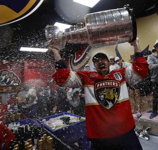 Brad Marchand #63 of the Florida Panthers lifts the Stanley Cup in to the locker room after their win over the Edmonton Oilers in Game Six of the 2025 Stanley Cup Final at the Amerant Bank Arena on June 17, 2025 in Sunrise, Florida