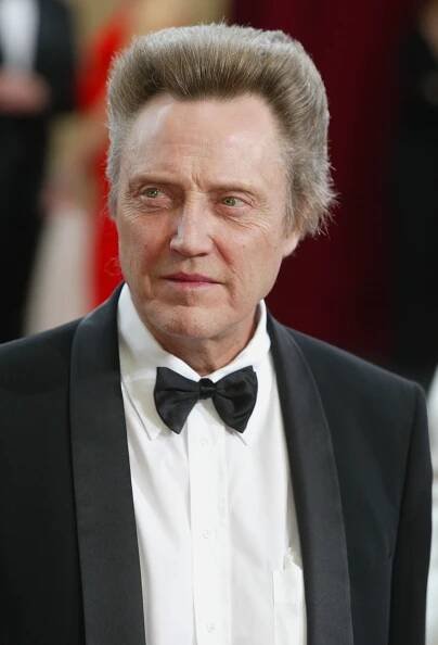 Christopher Walken in a formal suit with a bow tie at a red carpet event