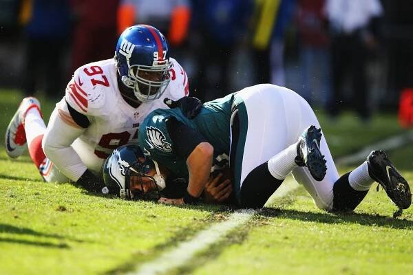 Eagles quarterback Matt Barkley face down after being sacked by Linval Joseph of the Giants.