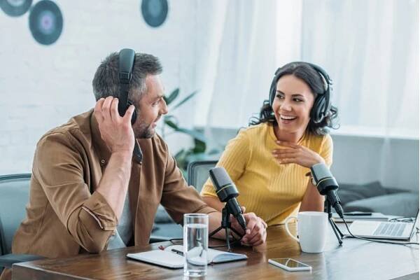dva veselí rozhlasoví hostitelé ve sluchátkách nahrávání podcastu ve vysílacím studiu - podcast - stock snímky, obrázky a fotky