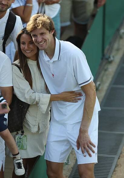 Nicolas Jarry celebrates with his wife after a Wimbledon tennis match.
