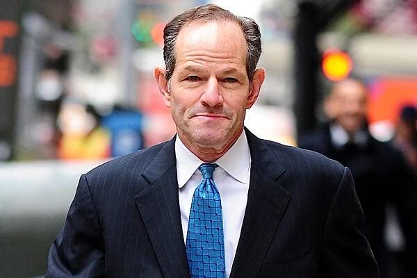 Eliot Spitzer walks through Midtown Manhattan.