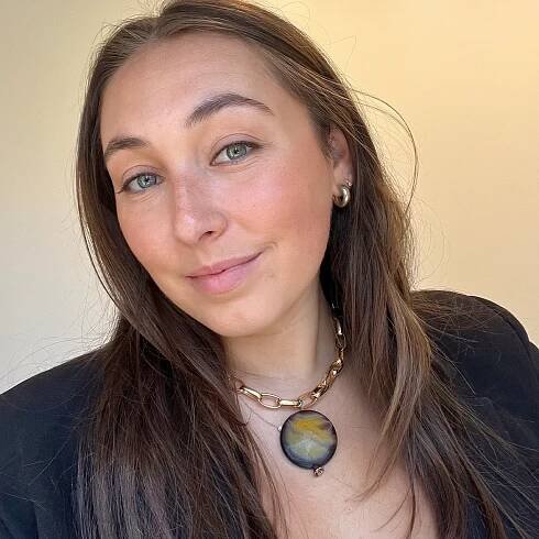woman wearing a large necklace