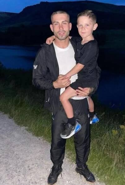 Ryan Livesey holding his son.
