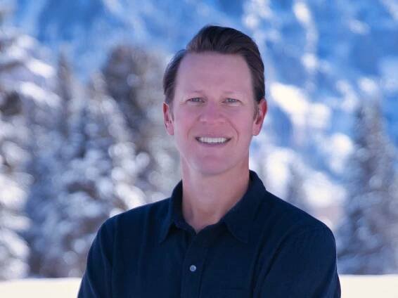 Matt Ellis, CEO and founder of Measurabl, in front of a snowy mountain.