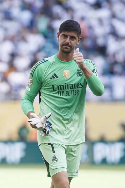 Thibaut Courtois of Real Madrid giving a thumbs up.