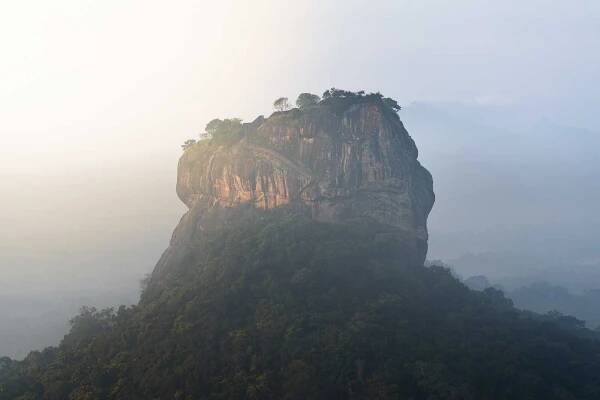 view of Sigiriya rock from the top of Pidurangala rock at sunrise