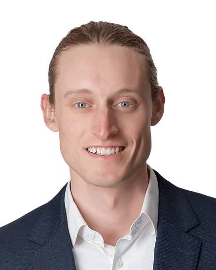 A man in a blue jacket and white shirt.