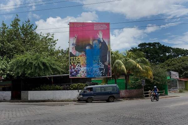 A billboard portraying President Daniel Ortega along with his wife and Vice-President Rosario Murillo is defaced by blue paint, the colors used by opposition groups. Managua, Nicaragua. August 1, 2018.