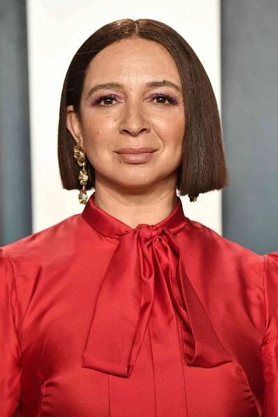Maya Rudolph wearing a red dress with her hair in a middle-parted blunt bob