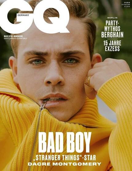 a man in yellow sweater on the cover of gq magazine with his hand under his ear