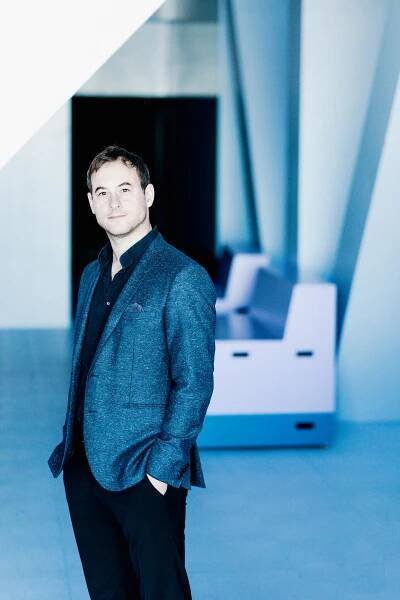 A white man wearing a blue jacket