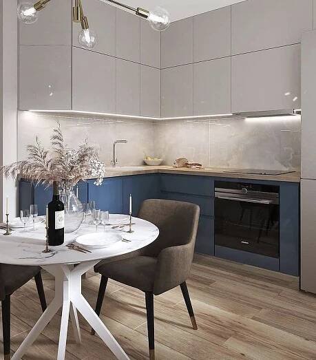 a white table with two chairs and a bottle of wine on it in a kitchen