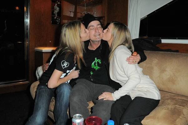 Charlie Sheen in a black T-shirt, black cap and black jeans. Natalie Kenly in a black T-shirt and jeans, and Bree Olson.  in a cream cardigan and jeans.