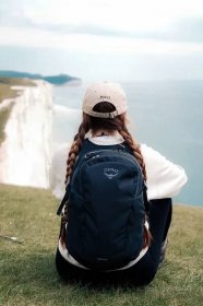 The image shows a girl looking out toward the sea along the Seven Sisters walk trail.