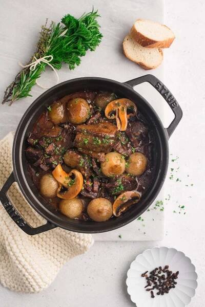 Beef Bourguignon in black pan on marble table